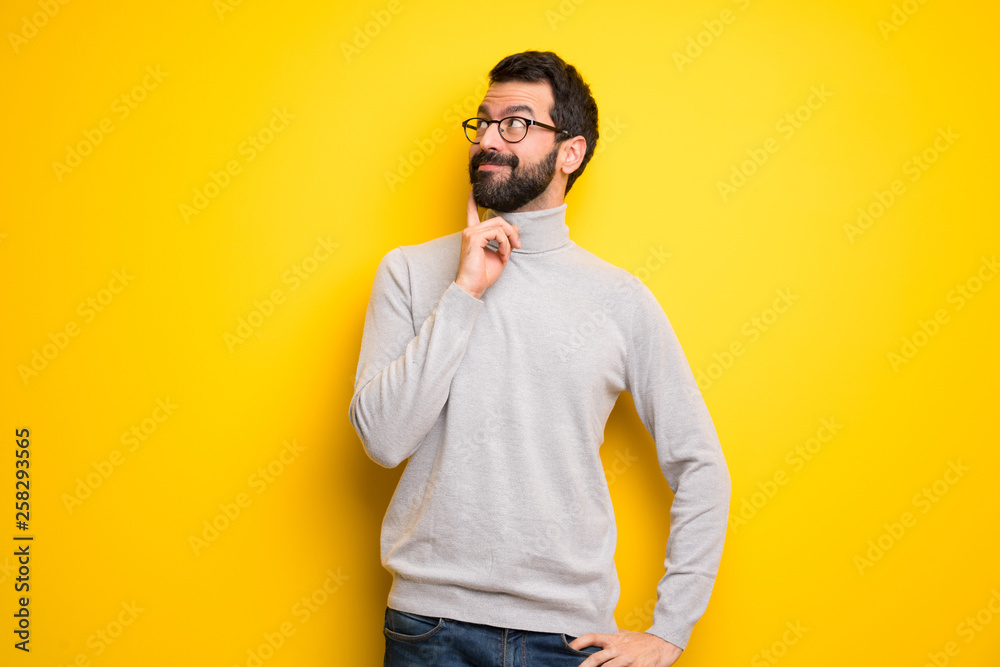 Man with beard and turtleneck thinking an idea while looking up Man with beard and turtleneck thinking an idea while looking up