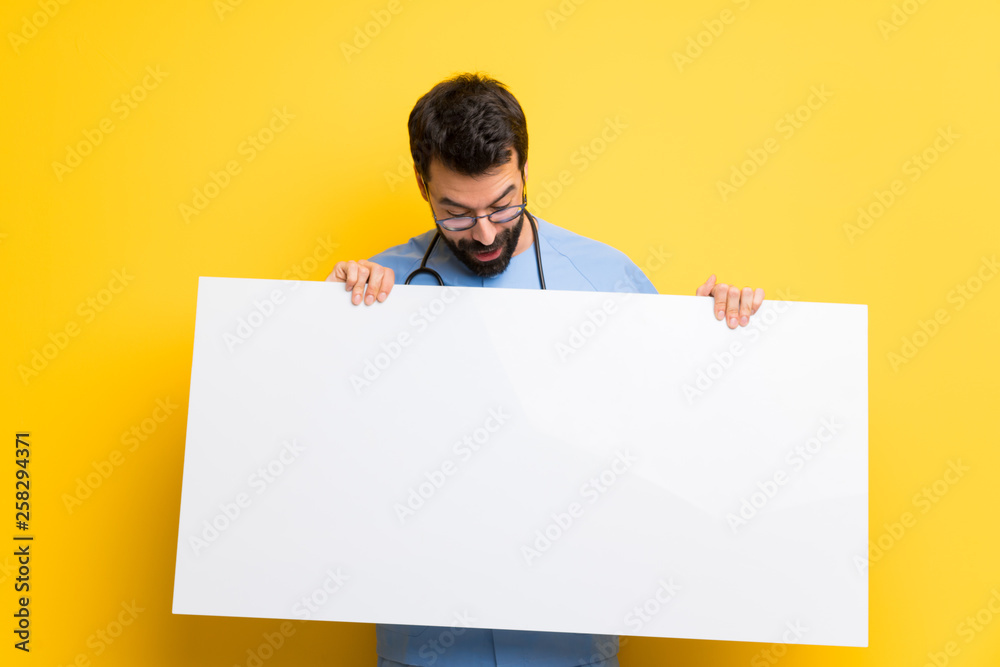 Surgeon doctor man holding an empty white placard Surgeon doctor man holding an empty white placard