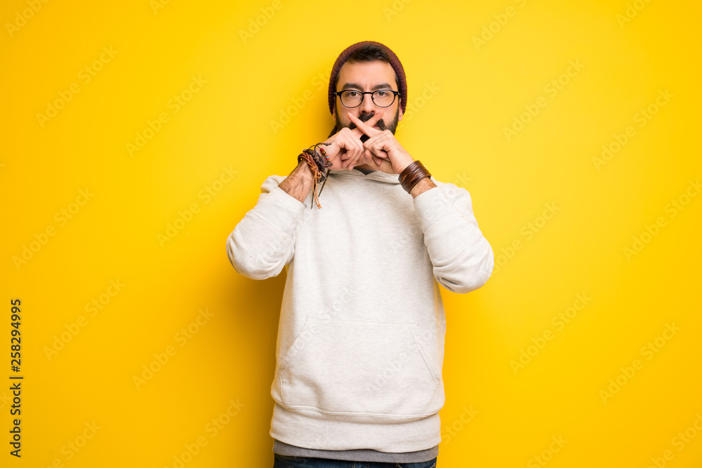 Hippie man with dreadlocks showing a sign of silence gesture Hippie man with dreadlocks showing a sign of silence gesture