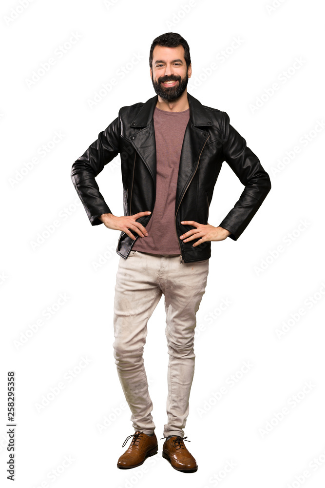 Handsome man with beard posing with arms at hip and smiling over isolated white background Handsome man with beard posing with arms at hip and smiling over isolated white background