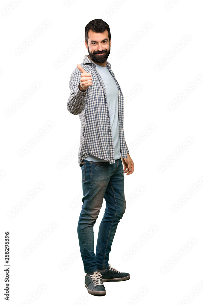 Handsome man with beard with thumbs up because something good has happened over isolated white background Handsome man with beard with thumbs up because something good has happened over isolated white background