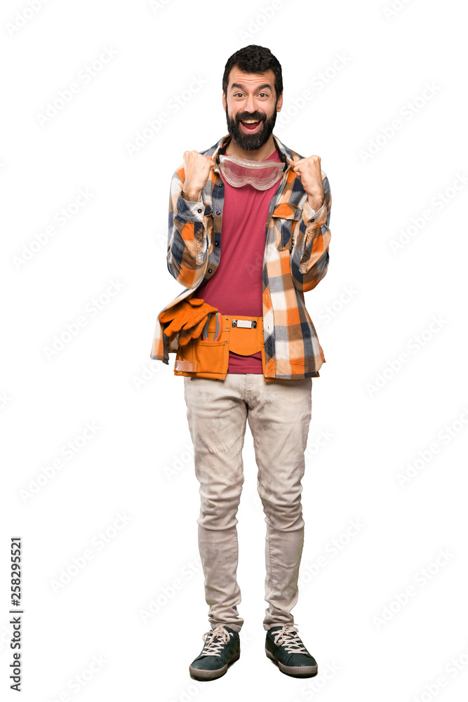Craftsmen man celebrating a victory in winner position over isolated white background Craftsmen man celebrating a victory in winner position over isolated white background