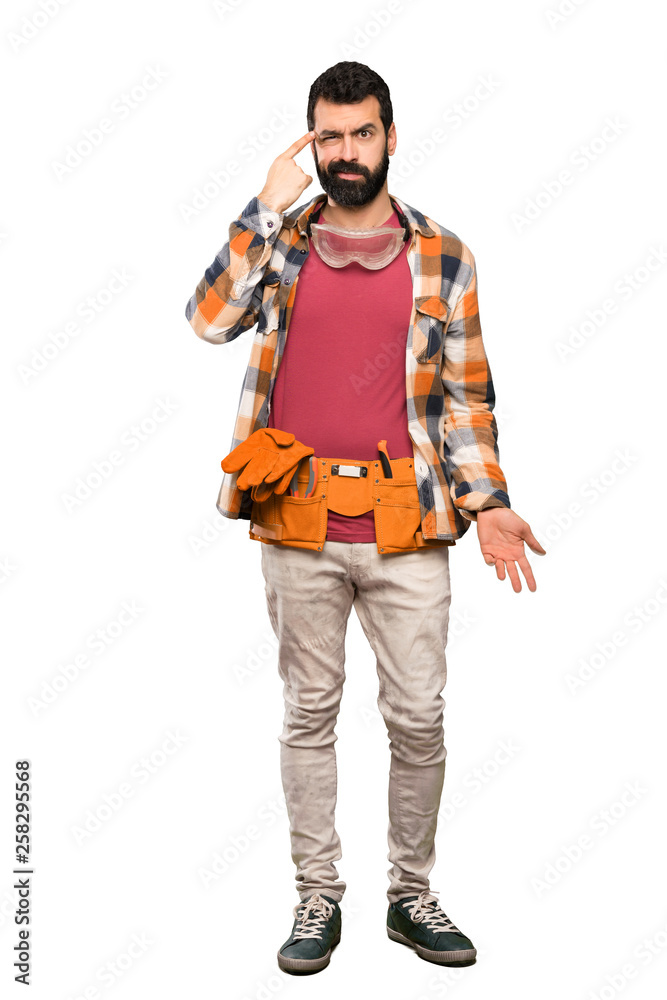 Craftsmen man making the gesture of madness putting finger on the head over isolated white background Craftsmen man making the gesture of madness putting finger on the head over isolated white background