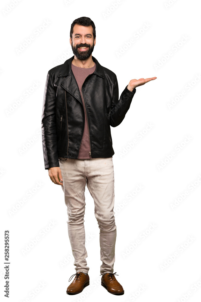 Handsome man with beard holding copyspace imaginary on the palm to insert an ad over isolated white background Handsome man with beard holding copyspace imaginary on the palm to insert an ad over isolated white background