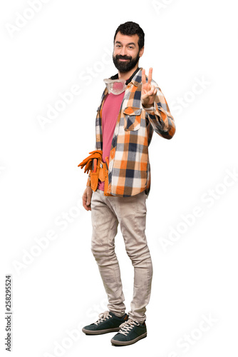 Craftsmen man smiling and showing victory sign over isolated white background