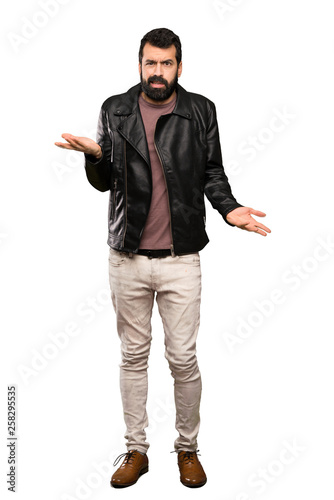 Handsome man with beard unhappy for not understand something over isolated white background