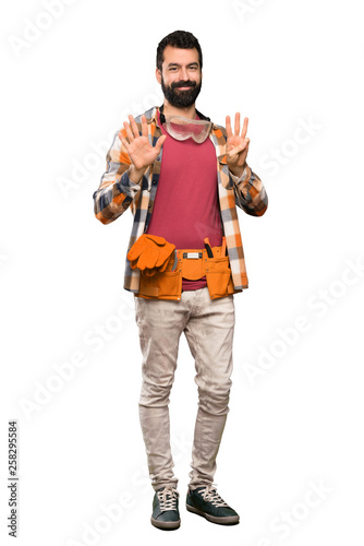 Craftsmen man counting eight with fingers over isolated white background © luismolinero