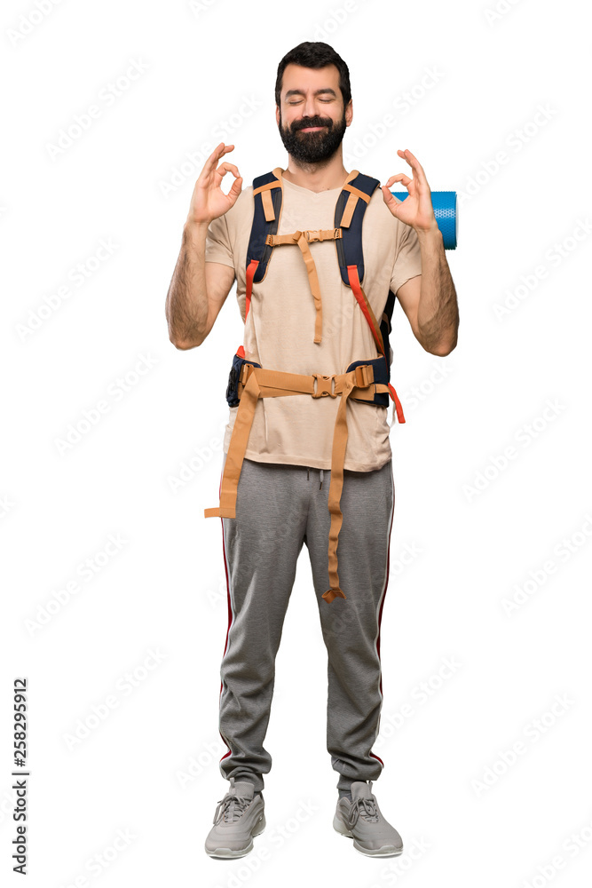 Hiker man in zen pose over isolated white background Hiker man in zen pose over isolated white background