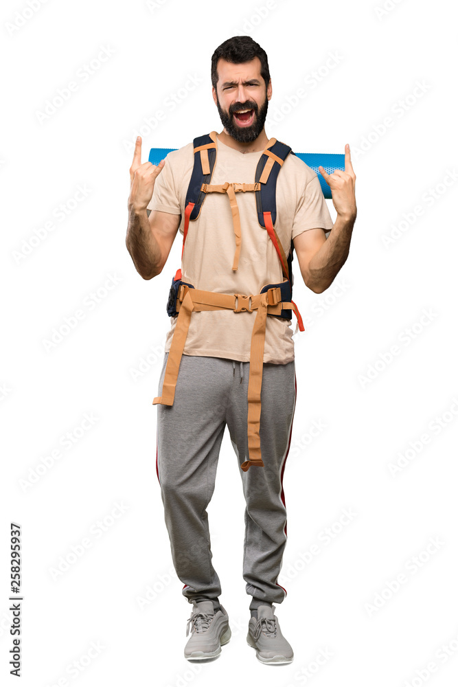 Hiker man making rock gesture over isolated white background Hiker man making rock gesture over isolated white background