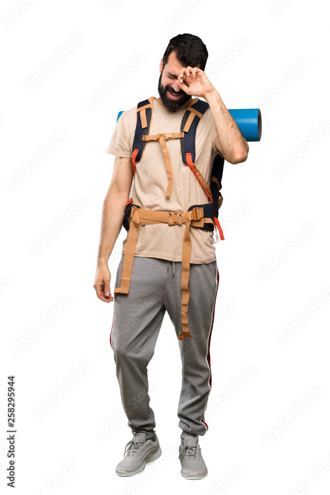 Hiker man with tired and sick expression over isolated white background Hiker man with tired and sick expression over isolated white background