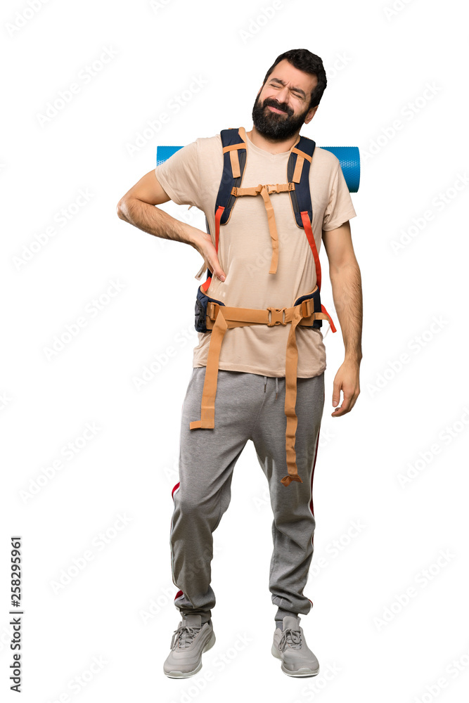 Hiker man suffering from backache for having made an effort over isolated white background Hiker man suffering from backache for having made an effort over isolated white background