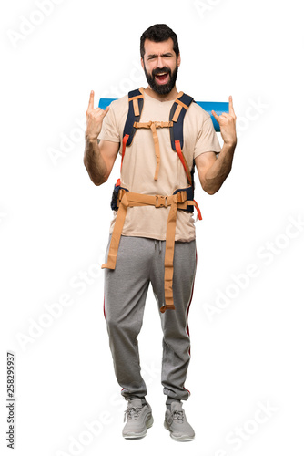 Hiker man making rock gesture over isolated white background