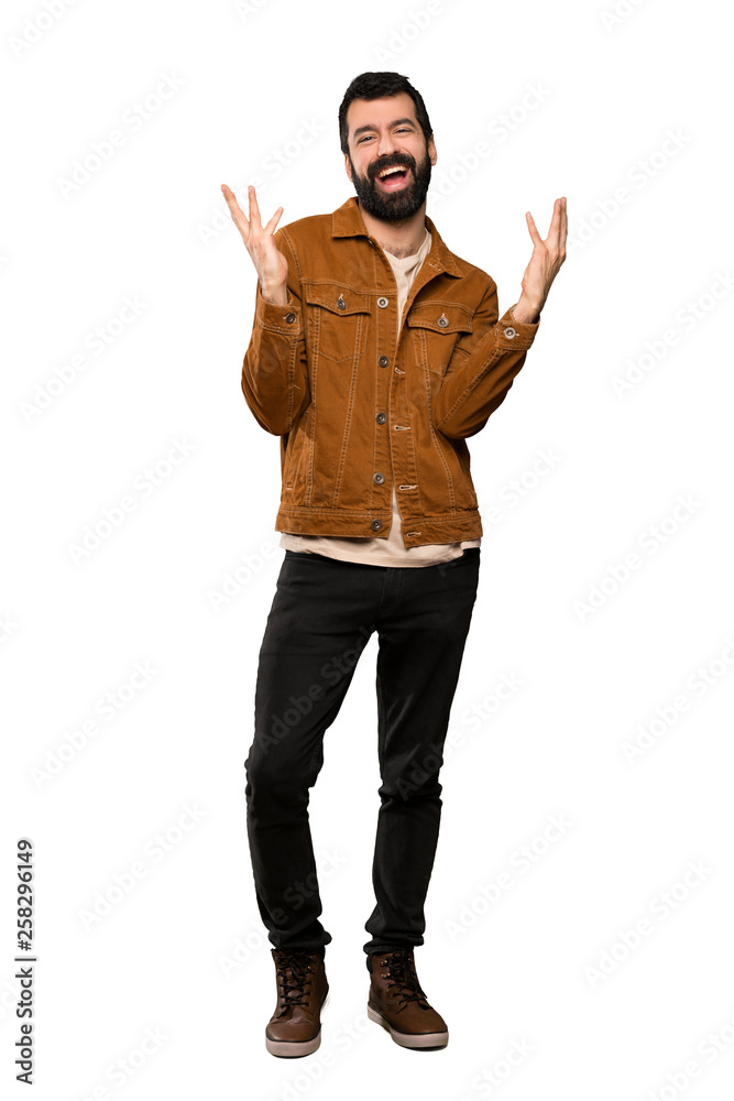 Handsome man with beard smiling a lot over isolated white background