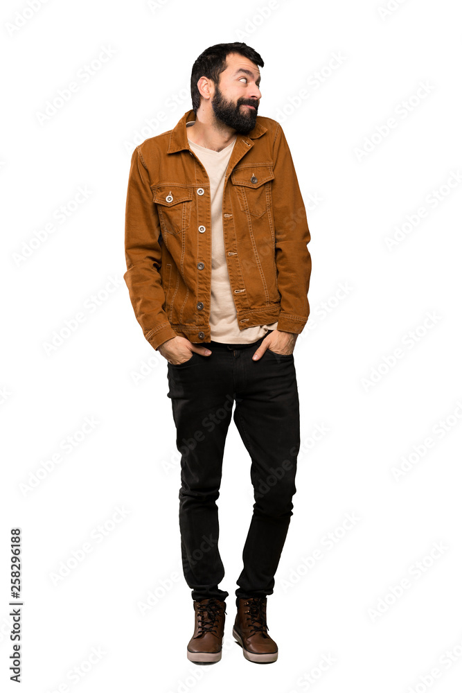 Handsome man with beard making doubts gesture looking side over isolated white background Handsome man with beard making doubts gesture looking side over isolated white background