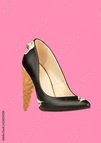 An alternative shoes. Another view of sweets for woman. A black leather female shoe filled with cream and icecream horn as a heel against coral background. Modern design. Contemporary art collage.