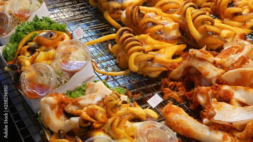 National Asian Exotic ready to eat seafood at night street market food court in Thailand. Delicious Grilled Prawns or Shrimps and other snacks photo