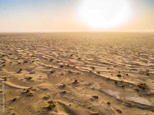 Sundown in desert.Big sand dunes panorama. Desert or beach sand textured background. 