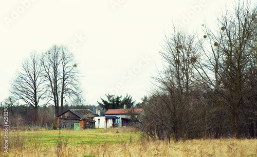 Abandoned house and barn in the Polish countryside. © Anna