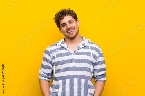 Wallpaper Mural Blonde man over yellow wall With happy expression Torontodigital.ca