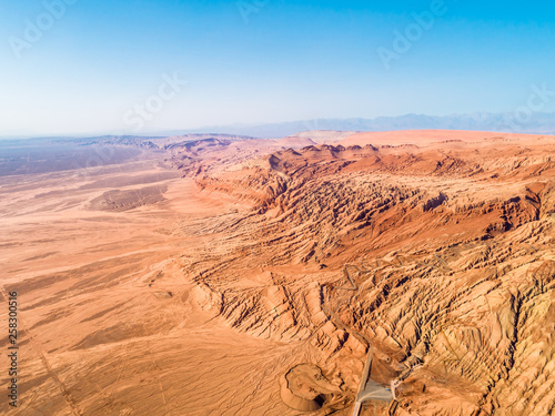 The Flaming Mountains are barren eroded red sandstone hills in Tian Shan Mountain range Xinjiang China. 