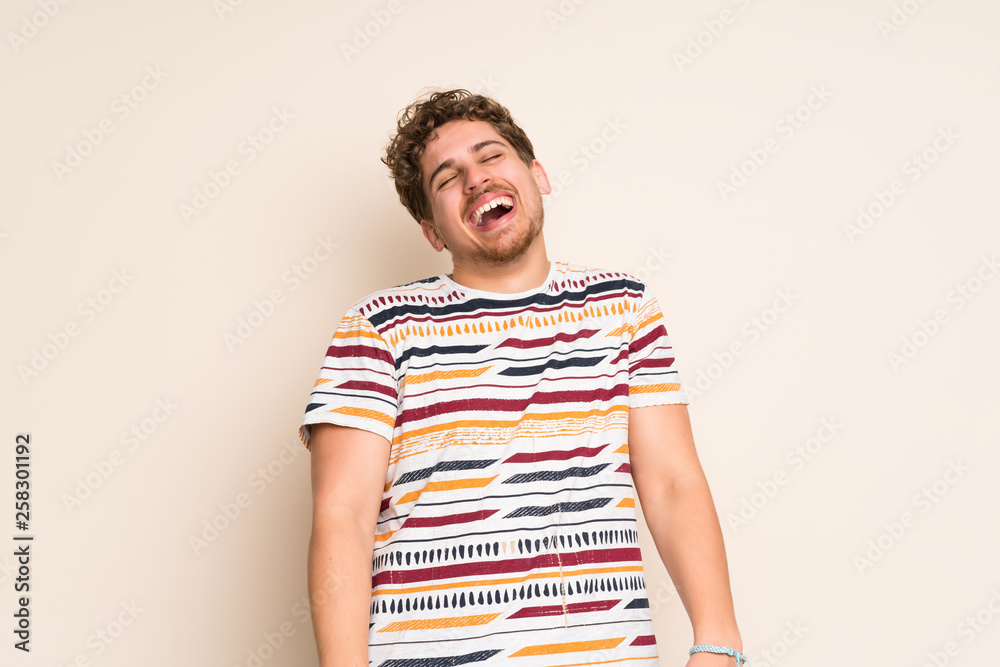 Blonde man over isolated wall smiling Blonde man over isolated wall smiling