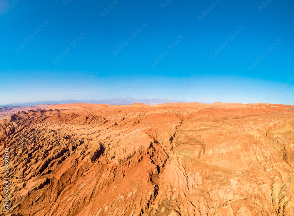 The Flaming Mountains are barren eroded red sandstone hills in Tian Shan Mountain range Xinjiang China. 