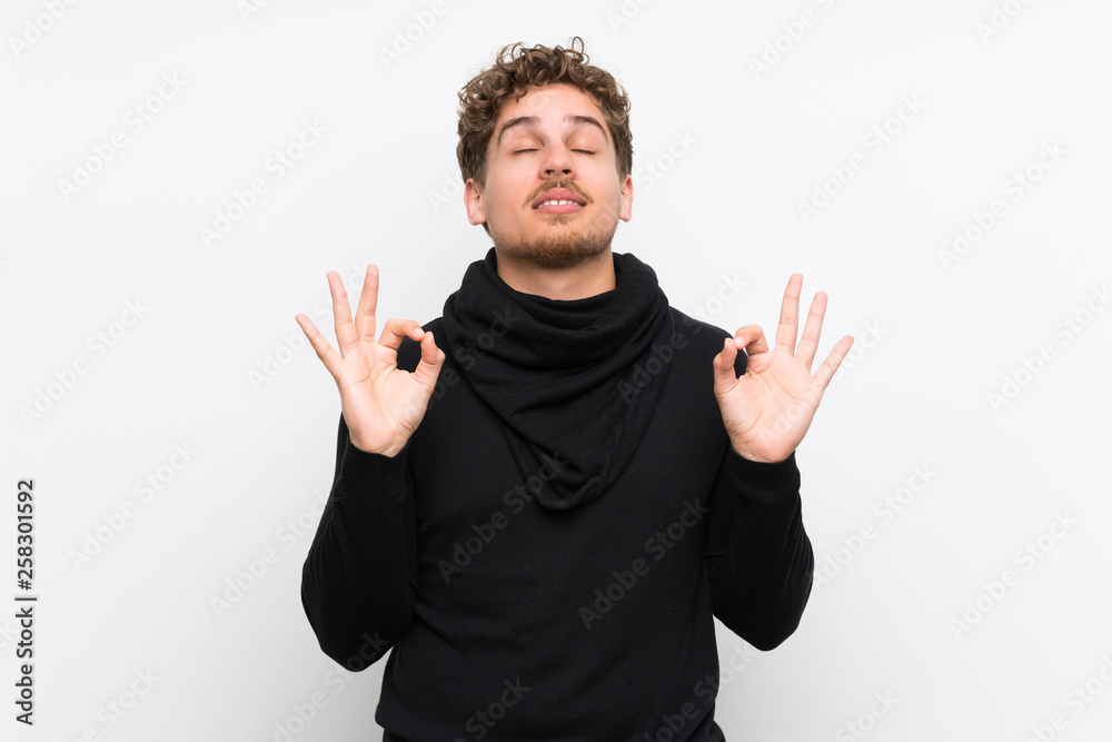 Fototapeta premium Blonde man over isolated white wall in zen pose
