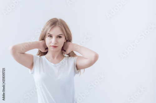 Attractive young girl holds hair with her hands