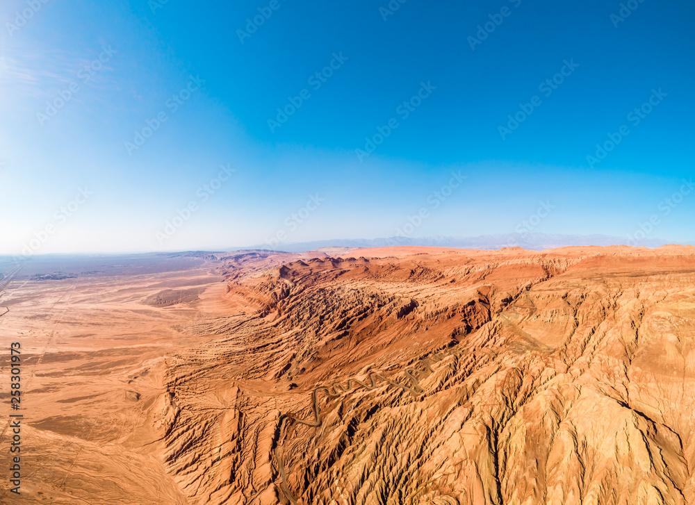 Naklejka premium The Flaming Mountains are barren eroded red sandstone hills in Tian Shan Mountain range Xinjiang China. 