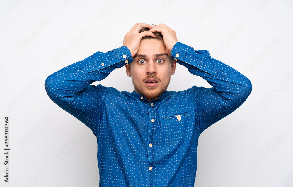 Blonde man with blue shirt with surprise facial expression Blonde man with blue shirt with surprise facial expression