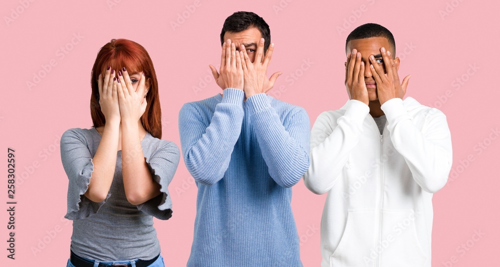 Group of three friends covering eyes by hands Group of three friends covering eyes by hands