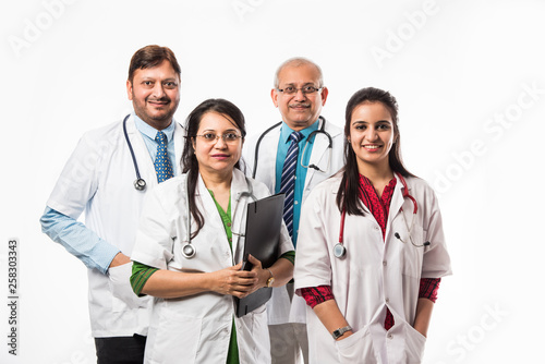 Group of Indian medical doctors, male and female standing isolated on white background, selective focus