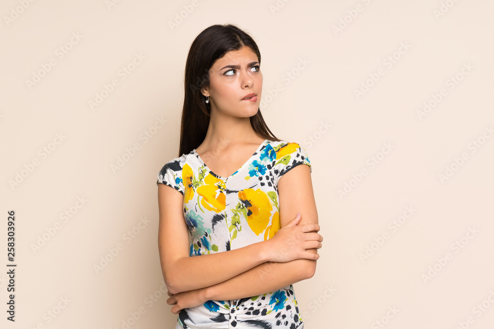 Teenager girl with floral dress with confuse face expression Teenager girl with floral dress with confuse face expression
