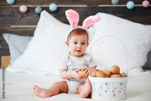 Canvas Print Portrait of adorable baby with bunny ears and easter basket