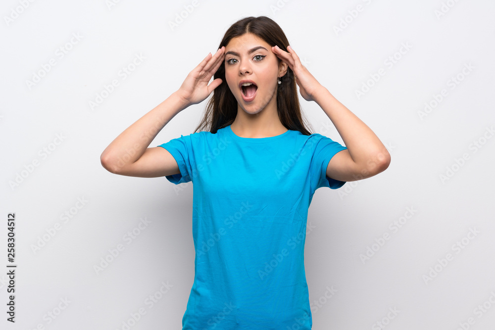 Teenager girl with blue shirt with surprise expression Teenager girl with blue shirt with surprise expression