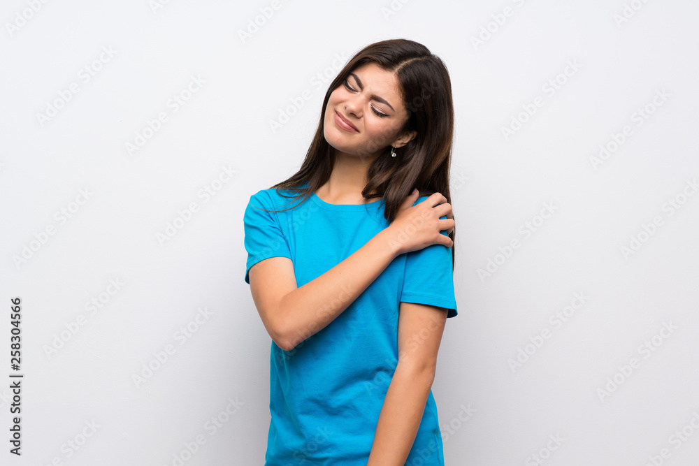 Teenager girl with blue shirt suffering from pain in shoulder for having made an effort Teenager girl with blue shirt suffering from pain in shoulder for having made an effort