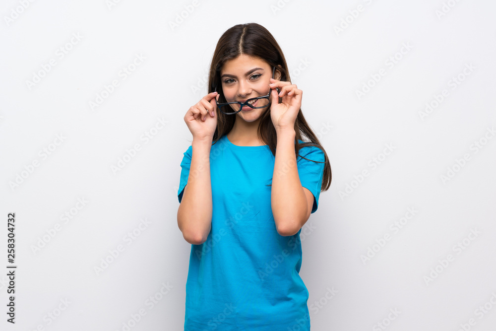 Teenager girl with blue shirt with glasses and surprised Teenager girl with blue shirt with glasses and surprised