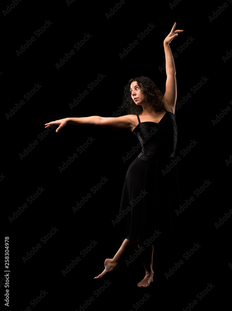 Girl ballet dancer on black background