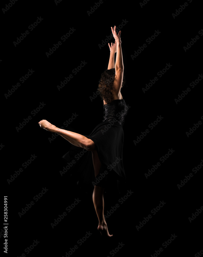 Girl ballet dancer on black background