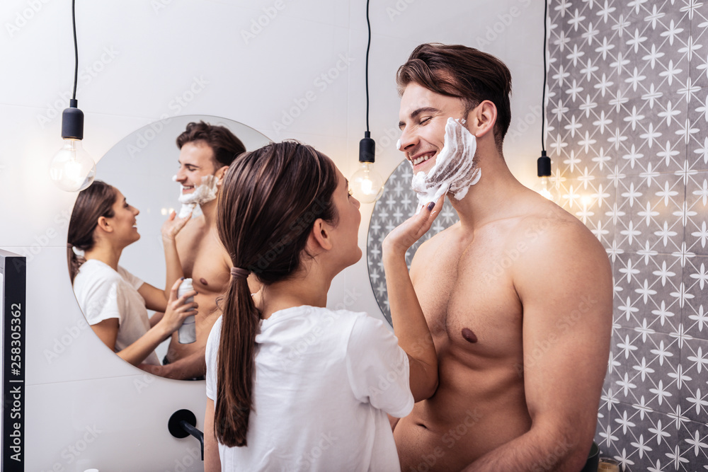 Husband with nice sexy abs hugging wife putting shaving foam Stock Photo Adobe Stock photo