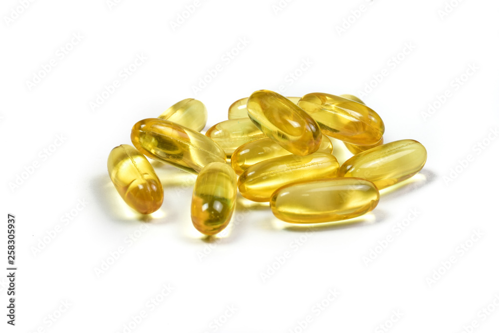 Close up of fish oil capsules isolated on white background. Supplementary food background. Omega 3. Vitamin E. Close up of fish oil capsules isolated on white background. Supplementary food background. Omega 3. Vitamin E.