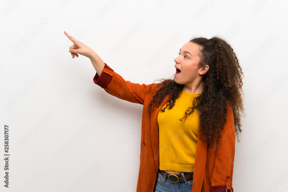 Teenager girl with coat pointing away Teenager girl with coat pointing away