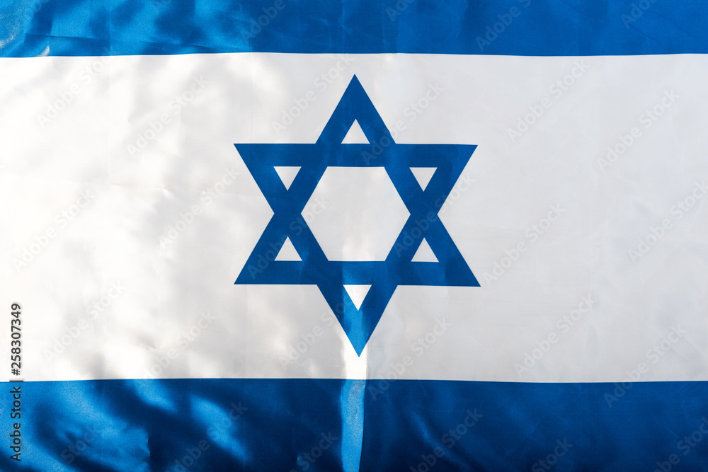close up of national israel flag with blue star of david close up of national israel flag with blue star of david