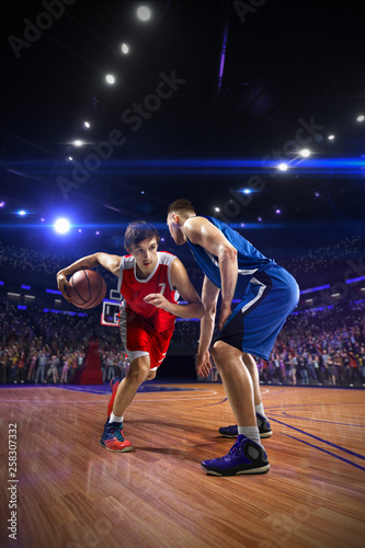 Basketball player n action. around Arena with blue light spot