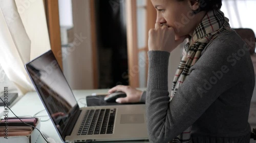 The girl is a student sitting at the table and preparing for the exam.