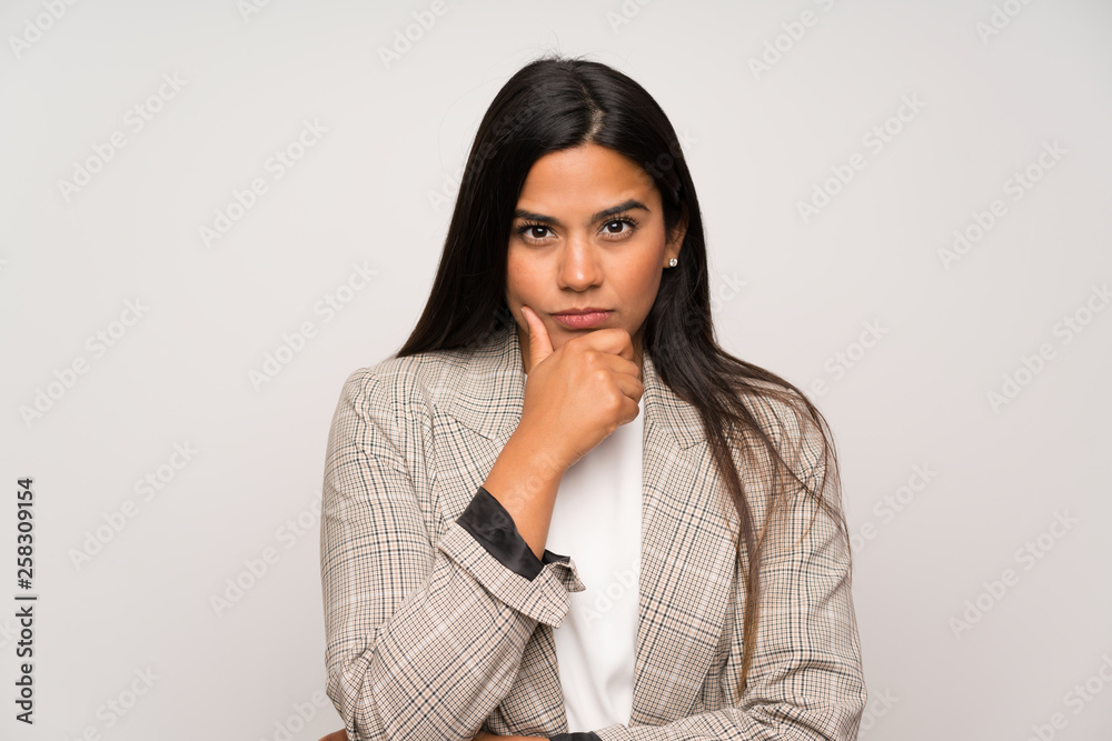 Young Colombian girl over white wall portrait