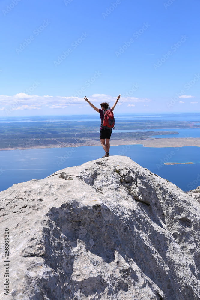 Woman is standing on the summit and feel free Woman is standing on the summit and feel free