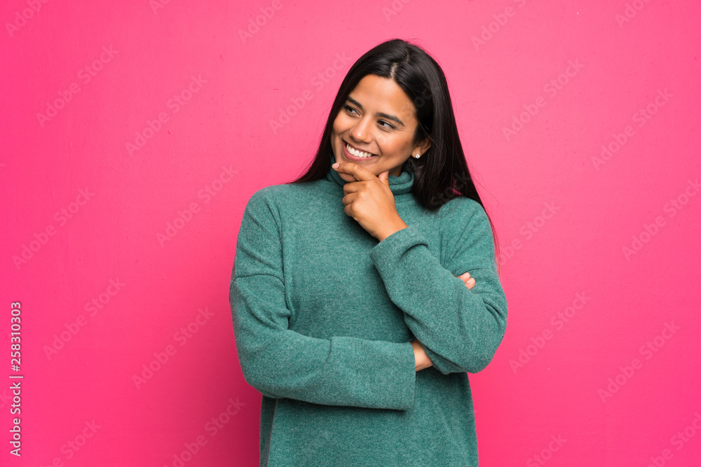 Young Colombian girl with green sweater looking to the side Young Colombian girl with green sweater looking to the side
