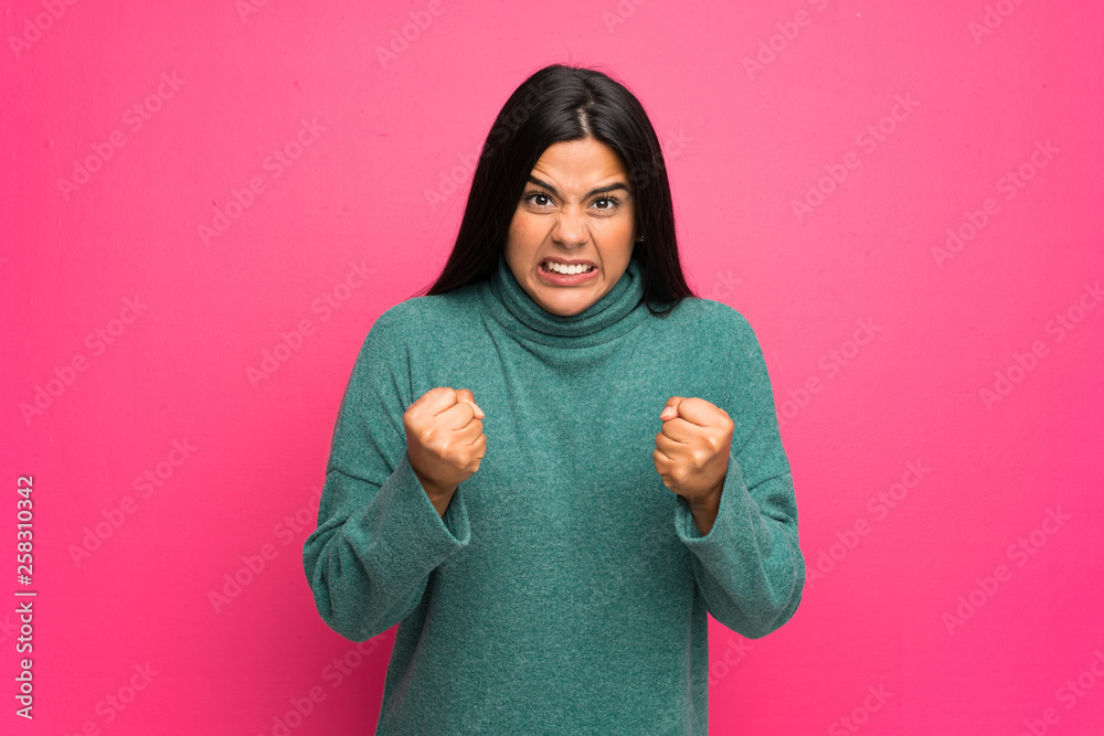 Young Colombian girl with green sweater frustrated by a bad situation Young Colombian girl with green sweater frustrated by a bad situation