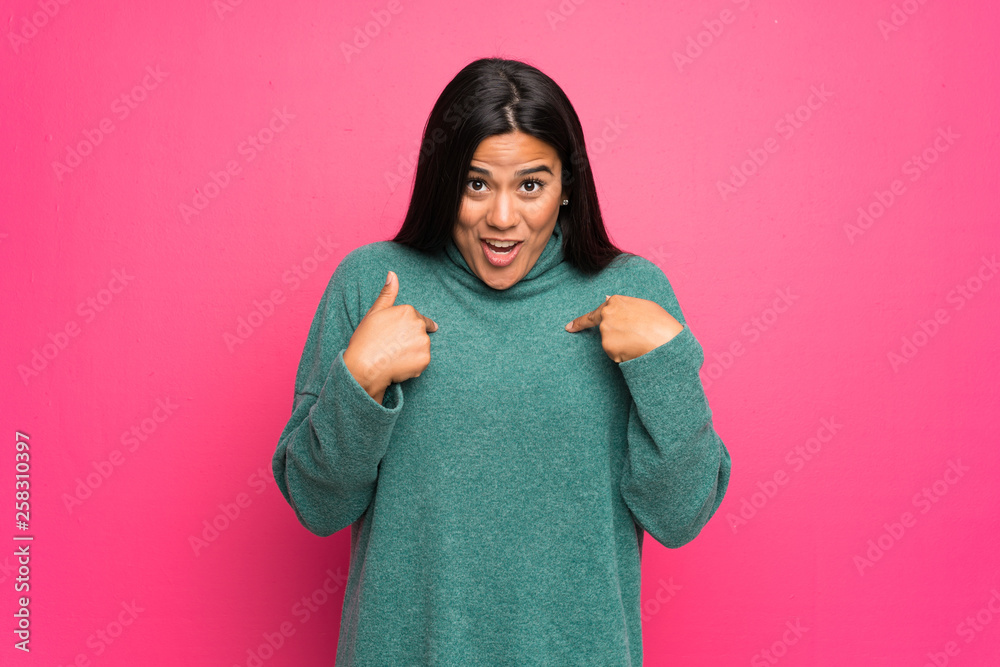 Young Colombian girl with green sweater with surprise facial expression Young Colombian girl with green sweater with surprise facial expression